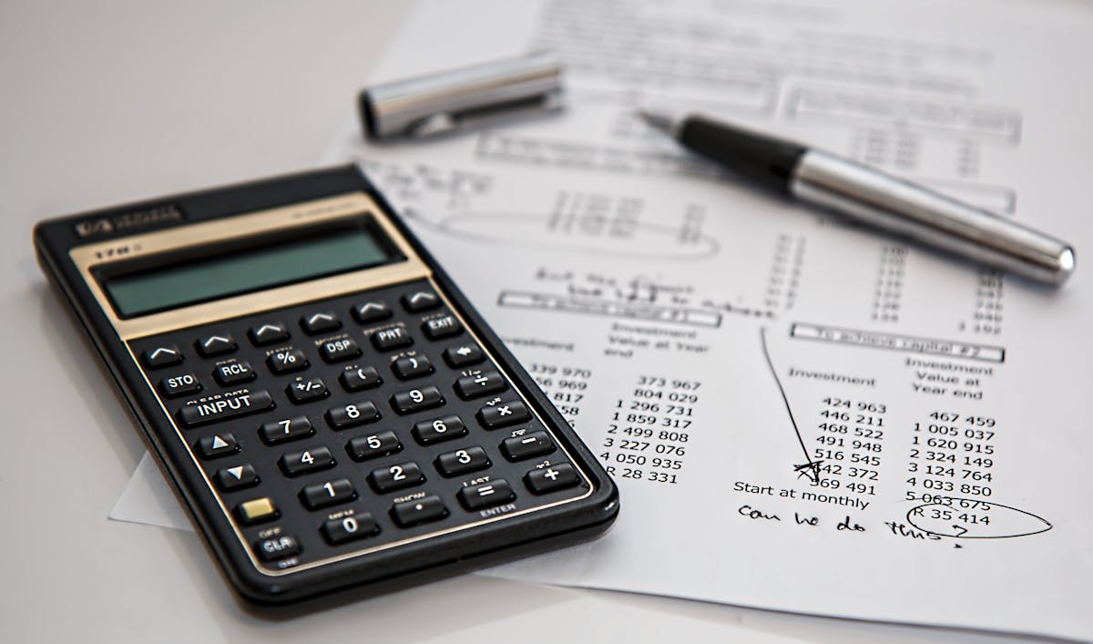 Calculator and financial documents for tracking cleaning business margins
